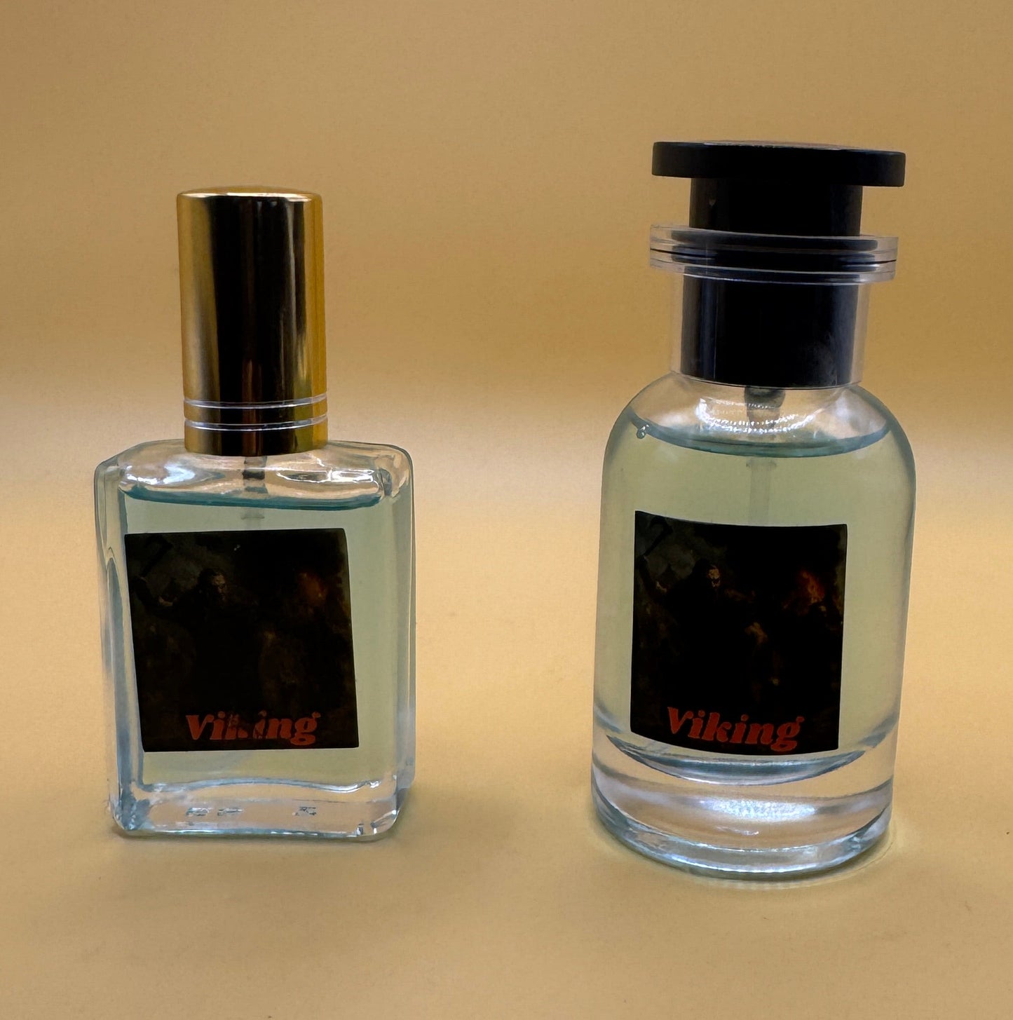 Two perfume bottles on a beige surface with a neutral background