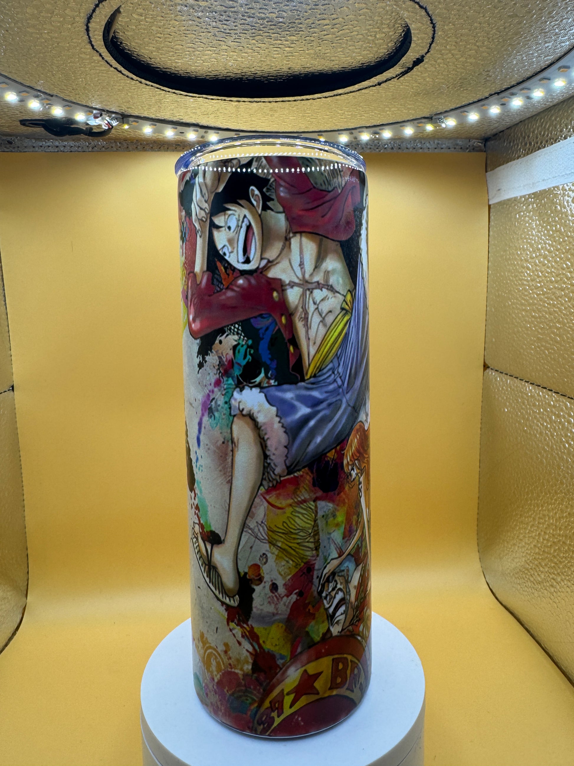 Cylindrical product with artistic design on a yellow surface